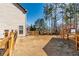 Large backyard with wooden fence, mature trees, and a storage shed along the back fence line at 115 Greenbrier Way, Canton, GA 30114