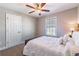 Neutral bedroom with window providing natural light and a ceiling fan for comfort at 115 Greenbrier Way, Canton, GA 30114