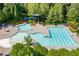 Aerial view of a community pool, surrounded by lush landscaping, and featuring a slide and ample seating at 115 Greenbrier Way, Canton, GA 30114
