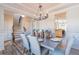 Elegant dining room featuring modern decor, stylish chandelier and easy access to the stairs at 115 Greenbrier Way, Canton, GA 30114