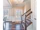 Inviting entrance with wood floors, staircase, and paneled walls offers a warm welcome at 115 Greenbrier Way, Canton, GA 30114