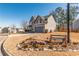 Well-maintained home on corner lot, featuring stone accents and charming flowerbed with a wooden bench at 115 Greenbrier Way, Canton, GA 30114