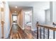 Upstairs hallway with wood floors leading to bedrooms, each with overhead lighting at 115 Greenbrier Way, Canton, GA 30114