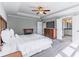 Comfortable main bedroom features tray ceiling, ceiling fan, fireplace, and ensuite bathroom at 115 Greenbrier Way, Canton, GA 30114