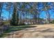 Large backyard with mature trees and a storage shed at 1357 Ridgewood Dr, Lilburn, GA 30047
