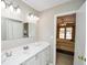 Bathroom with white vanity, and view into bedroom with king-size bed at 1357 Ridgewood Dr, Lilburn, GA 30047