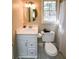 Clean bathroom with white vanity, toilet and shower at 1357 Ridgewood Dr, Lilburn, GA 30047
