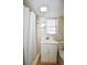 Simple bathroom with white vanity and shower at 1357 Ridgewood Dr, Lilburn, GA 30047
