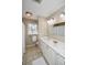Bright bathroom with white vanity, shower, and updated light fixtures at 1357 Ridgewood Dr, Lilburn, GA 30047