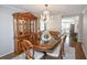 Bright dining room with hardwood floors, a chandelier, and views to the kitchen at 1357 Ridgewood Dr, Lilburn, GA 30047