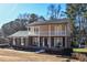 Two-story brick house with a balcony and rocking chairs on the porch at 1357 Ridgewood Dr, Lilburn, GA 30047