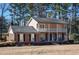 Charming two-story home with a brick facade, balcony, black shutters, and a well-manicured lawn at 1357 Ridgewood Dr, Lilburn, GA 30047