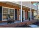 Brick porch with rocking chairs, shutters, and a front door at 1357 Ridgewood Dr, Lilburn, GA 30047