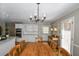 Kitchen with an island, hardwood floors, and a charming dining area at 1357 Ridgewood Dr, Lilburn, GA 30047
