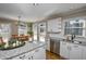 Bright kitchen featuring granite countertops, white cabinets, and a large island at 1357 Ridgewood Dr, Lilburn, GA 30047