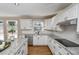 Modern kitchen with white cabinets, granite countertops, and stainless steel appliances at 1357 Ridgewood Dr, Lilburn, GA 30047