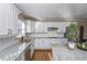 Updated kitchen with white cabinets, granite countertops, and stainless steel appliances at 1357 Ridgewood Dr, Lilburn, GA 30047