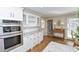Kitchen boasts granite counters, white cabinets, and stainless steel appliances at 1357 Ridgewood Dr, Lilburn, GA 30047