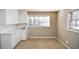 Small kitchen with white cabinets and countertops at 1357 Ridgewood Dr, Lilburn, GA 30047