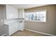 Small galley kitchen with white cabinets and countertops at 1357 Ridgewood Dr, Lilburn, GA 30047