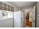 Laundry room with a refrigerator and view into the kitchen at 1357 Ridgewood Dr, Lilburn, GA 30047