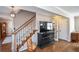 Spacious living room with hardwood floors, staircase, and large TV at 1357 Ridgewood Dr, Lilburn, GA 30047