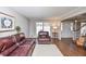 Living area with hardwood floors, leather furniture, and access to the entryway at 1357 Ridgewood Dr, Lilburn, GA 30047