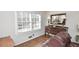 Living room corner with hardwood floors, a window with blinds, and an antique buffet at 1357 Ridgewood Dr, Lilburn, GA 30047