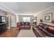 Living room with hardwood floors, leather furniture and views to the entryway at 1357 Ridgewood Dr, Lilburn, GA 30047