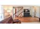 Living room with hardwood floors, a large TV, and a view of the staircase at 1357 Ridgewood Dr, Lilburn, GA 30047
