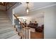 Elegant staircase with white railing and view of living room at 1357 Ridgewood Dr, Lilburn, GA 30047