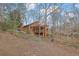 Wooded backyard offering privacy and tranquility with glimpses of the home's architecture and tiered landscaping at 3457 Winter Wood Cv, Marietta, GA 30062