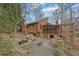 Multi-level backyard features a stone patio, a covered porch, lush landscaping, and plenty of space for outdoor activities at 3457 Winter Wood Cv, Marietta, GA 30062