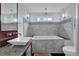 Bright bathroom showcasing a marble tiled wall, modern bathtub, and stylish pendant lighting at 3457 Winter Wood Cv, Marietta, GA 30062
