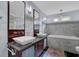Bathroom with marble tiling, dual sinks, granite countertop, modern fixtures, and soaking tub at 3457 Winter Wood Cv, Marietta, GA 30062