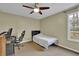 Bedroom with desk area, ceiling fan, and neutral carpet at 3457 Winter Wood Cv, Marietta, GA 30062