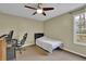 Neutral bedroom with a ceiling fan, chair, desk and window at 3457 Winter Wood Cv, Marietta, GA 30062