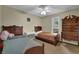 Bedroom featuring two beds, wood furniture, and a ceiling fan at 3457 Winter Wood Cv, Marietta, GA 30062