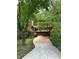 Charming home with an exterior showcasing lush greenery and a winding driveway at 3457 Winter Wood Cv, Marietta, GA 30062
