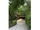 Charming home with an exterior showcasing lush greenery and a winding driveway at 3457 Winter Wood Cv, Marietta, GA 30062