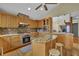 Open kitchen featuring wooden cabinets, stainless steel appliances, granite counters, and a tile backsplash at 3457 Winter Wood Cv, Marietta, GA 30062