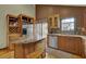 Kitchen featuring wooden cabinets, stainless steel appliances, granite counters, and an island at 3457 Winter Wood Cv, Marietta, GA 30062