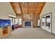 Large living room featuring a stone fireplace, beamed ceilings and many windows at 3457 Winter Wood Cv, Marietta, GA 30062
