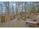 Charming stone patio with lounge chairs, a water feature, bench, and a cozy fire pit perfect for outdoor relaxation at 3457 Winter Wood Cv, Marietta, GA 30062