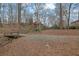 Natural setting with a small bridge over a stream, leading to a home nestled in a private wooded area with a pond at 3457 Winter Wood Cv, Marietta, GA 30062