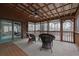Inviting screened porch features a ceiling fan, comfortable seating, and tranquil wooded views through the screen at 3457 Winter Wood Cv, Marietta, GA 30062