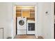 A modern laundry room features a washer and dryer, complemented by overhead shelving at 424 Lindbergh Ne Dr # 111, Atlanta, GA 30305