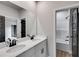 A bathroom featuring dual sinks, elegant countertops, and a view of the shower at 8971 Callaway Dr, Winston, GA 30187