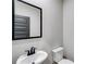 A half-bathroom with a modern sink and toilet at 8971 Callaway Dr, Winston, GA 30187