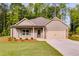 Charming one-story home with a two-car garage, nicely landscaped front yard, and craftsman-style details at 8971 Callaway Dr, Winston, GA 30187